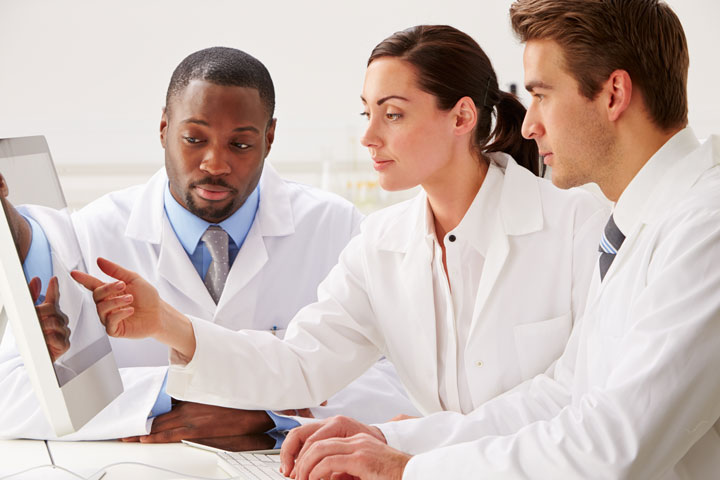 Group Of Scientists Checking Laboratory Results On Computer